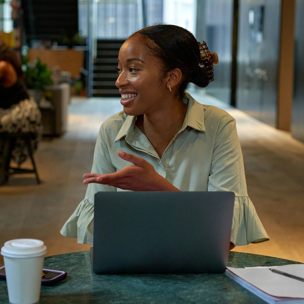 A woman sat at a laptop