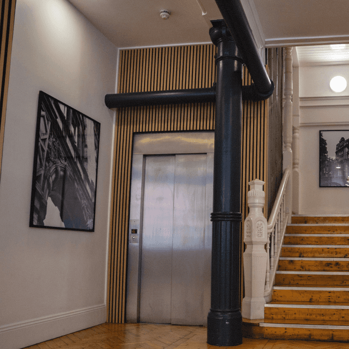 um membro da equipe do Capsule está trabalhando em um sofá no escritório.