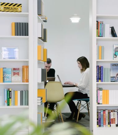 two Capsule team members working together in a small office.