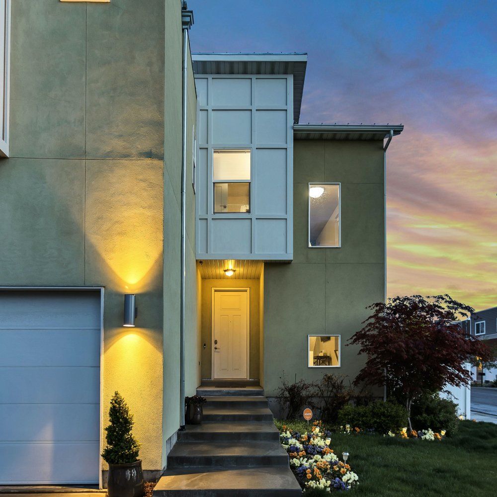 Modern house in front of a sun-setting sky