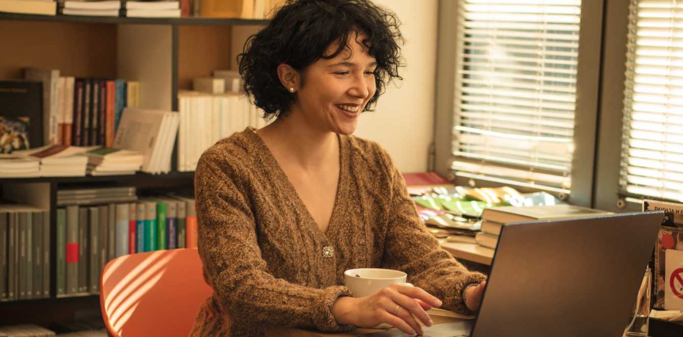 Person sitting at their desk with a laptop